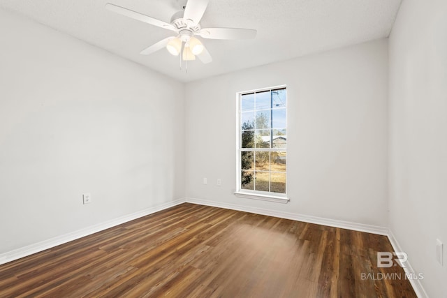 unfurnished room featuring dark hardwood / wood-style flooring and ceiling fan