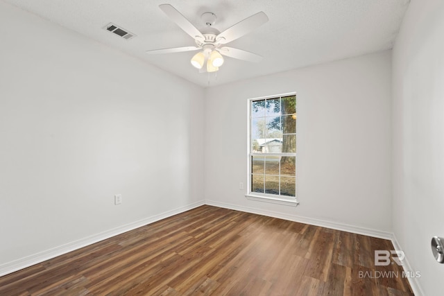 spare room featuring dark hardwood / wood-style floors and ceiling fan