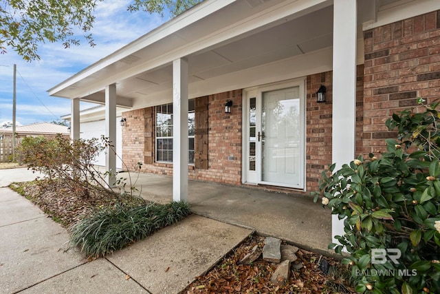 view of exterior entry featuring a porch