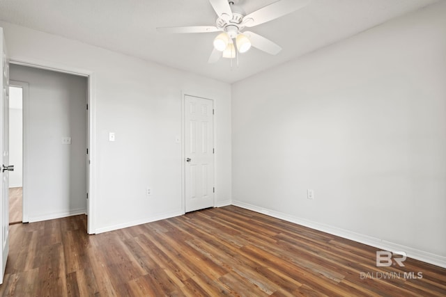 unfurnished bedroom featuring ceiling fan and dark hardwood / wood-style flooring