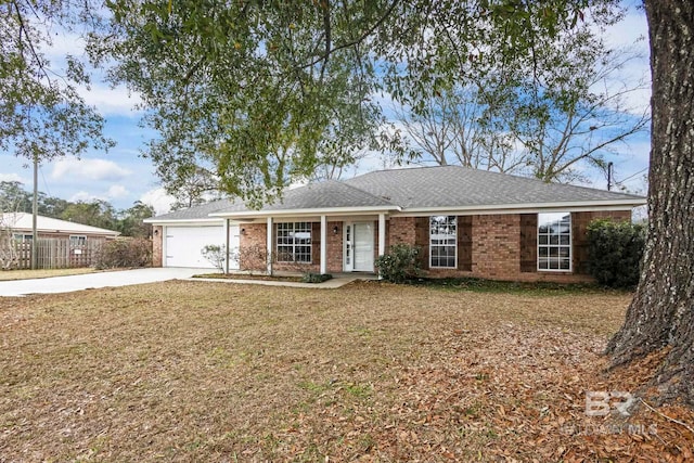 ranch-style home featuring a garage and a front lawn