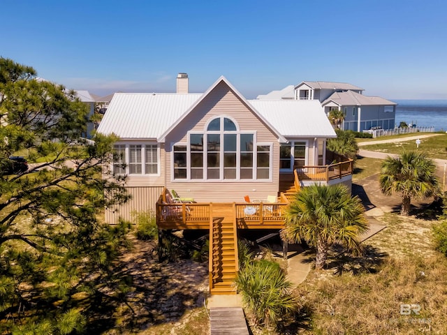 rear view of house with a deck with water view