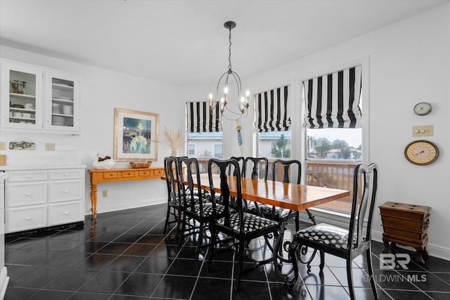 tiled dining space featuring a chandelier