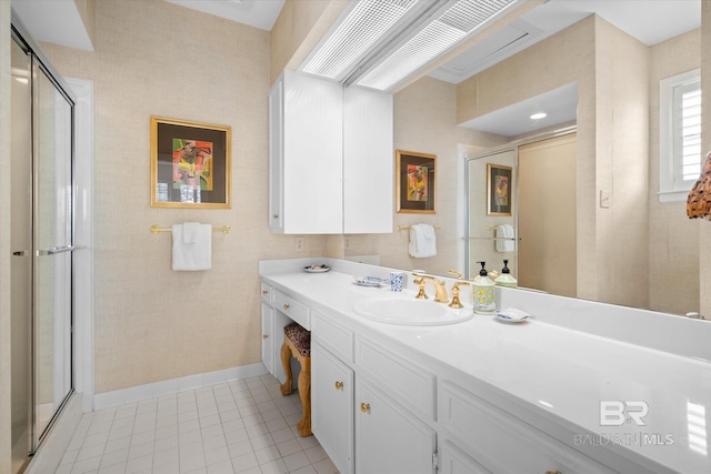 bathroom featuring tile patterned flooring, vanity, and a shower with door