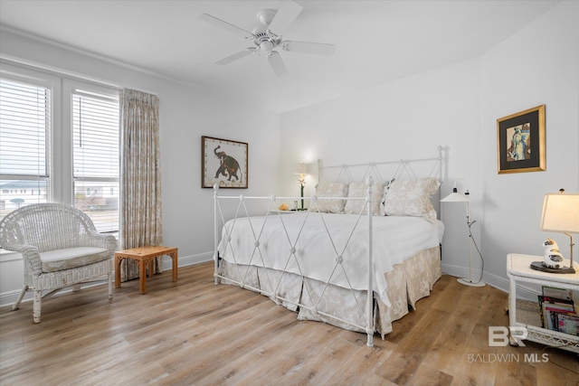 bedroom with ceiling fan and light wood-type flooring