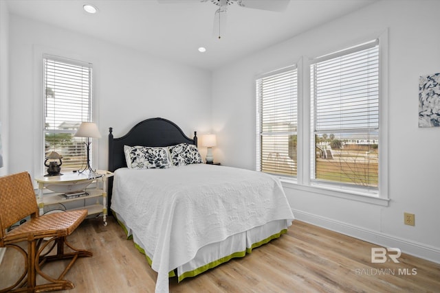 bedroom with hardwood / wood-style flooring and ceiling fan