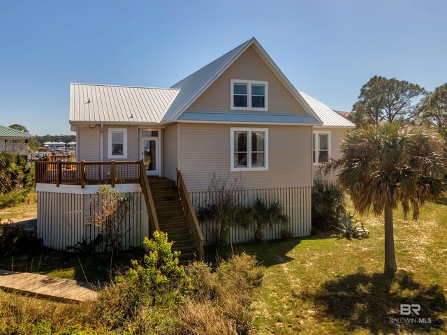 back of house featuring a deck and a lawn