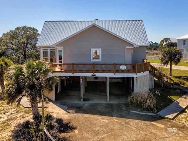 back of property with a carport and a deck