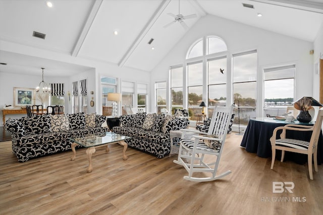 living room featuring beamed ceiling, high vaulted ceiling, ceiling fan with notable chandelier, and light wood-type flooring