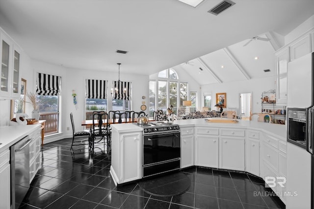 kitchen with white cabinetry, stainless steel dishwasher, black range with electric stovetop, and kitchen peninsula