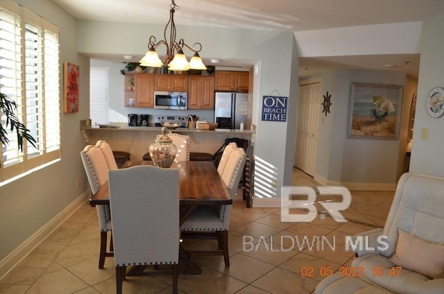 dining room featuring a notable chandelier and light tile patterned flooring