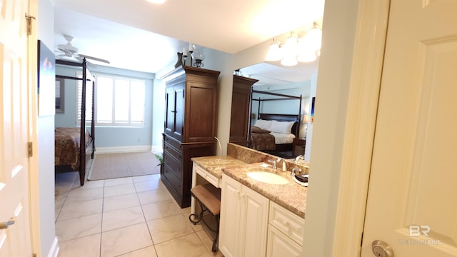 bathroom with tile patterned floors, vanity, and ceiling fan