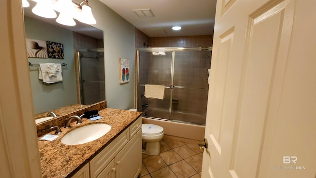 full bathroom with tile patterned floors, shower / bath combination with glass door, vanity, and toilet