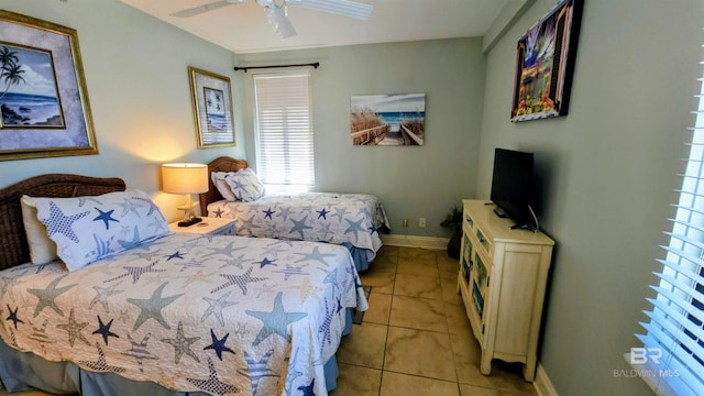 tiled bedroom featuring ceiling fan