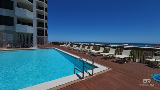 view of swimming pool with a water view