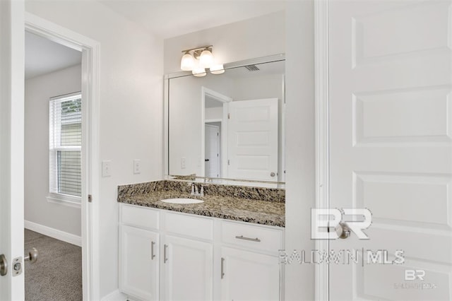 bathroom with vanity and baseboards