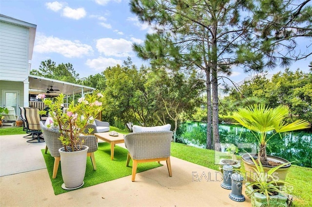 view of patio / terrace featuring a water view and a ceiling fan