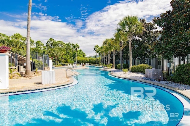 pool featuring fence and a patio