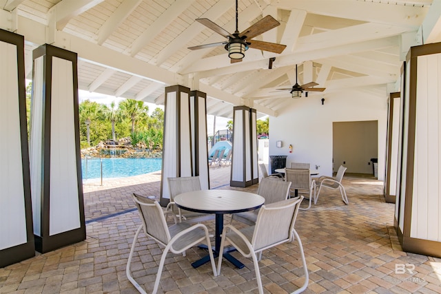 view of patio featuring outdoor dining space, an outdoor pool, and ceiling fan