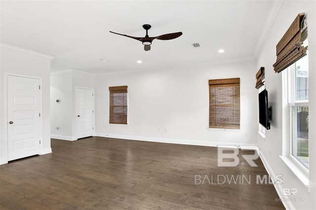 unfurnished room with baseboards, visible vents, dark wood-style floors, ceiling fan, and ornamental molding