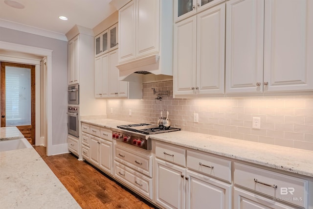 kitchen with stainless steel gas stovetop, white cabinetry, and light stone countertops