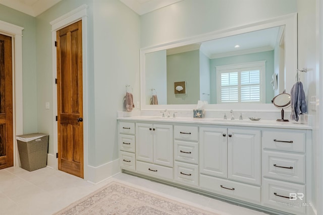 bathroom featuring tile patterned flooring, vanity, and crown molding