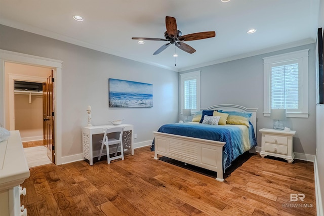 bedroom featuring ceiling fan, ornamental molding, and light hardwood / wood-style floors