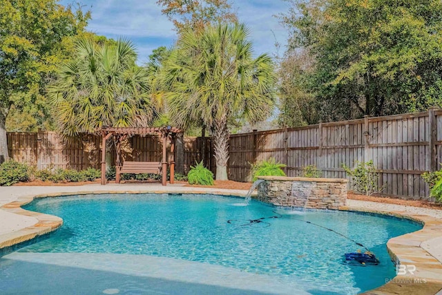 view of pool with a pergola and pool water feature