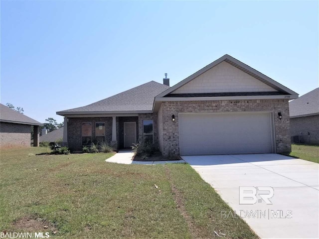 view of front of house featuring a front yard and a garage