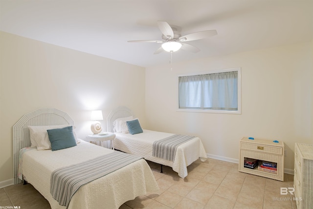 bedroom featuring light tile patterned floors, a ceiling fan, and baseboards