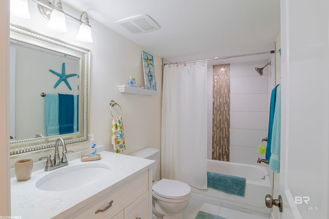 full bathroom featuring shower / bath combo with shower curtain, tile patterned floors, toilet, and vanity