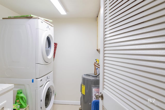 laundry room featuring stacked washer / dryer, baseboards, and water heater