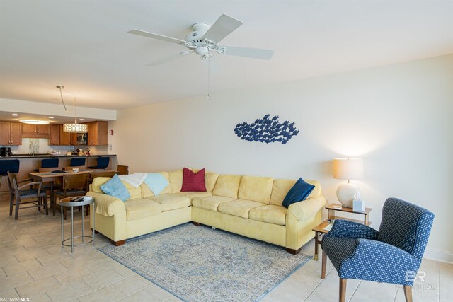 tiled living room with ceiling fan