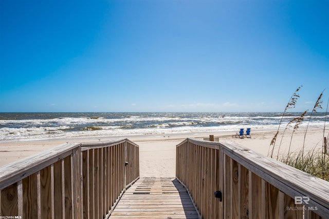 view of community featuring a beach view and a water view