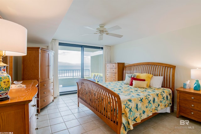 tiled bedroom featuring ceiling fan and access to outside