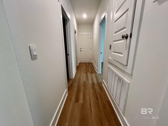 corridor featuring wood-type flooring