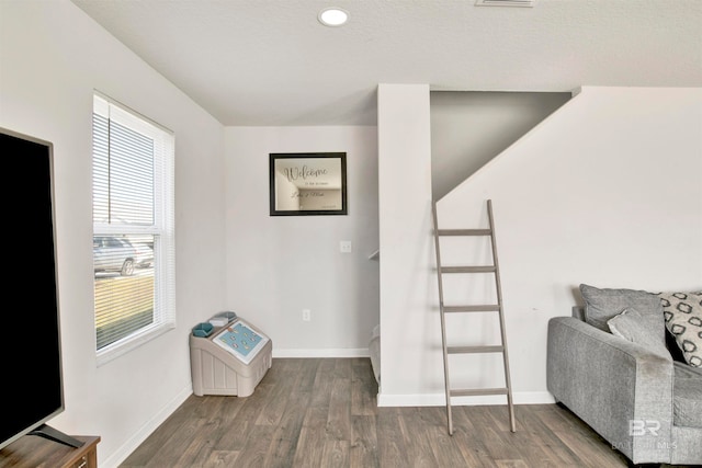 sitting room with a textured ceiling and wood-type flooring