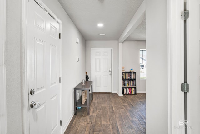 foyer with dark hardwood / wood-style floors and a textured ceiling