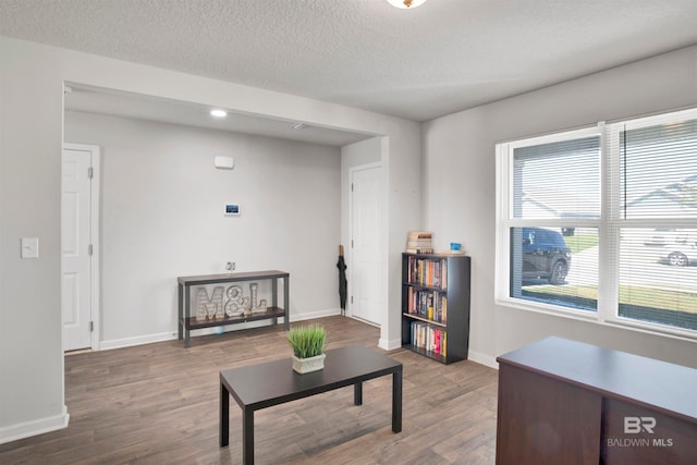 interior space featuring a textured ceiling and wood-type flooring