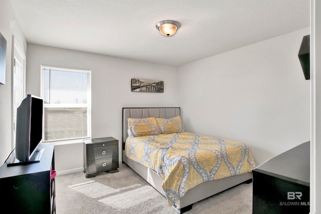 carpeted bedroom with a textured ceiling