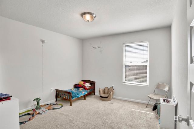 rec room with light carpet and a textured ceiling