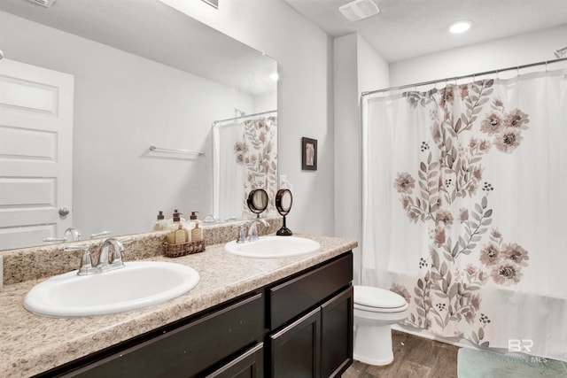 full bathroom with vanity, toilet, wood-type flooring, and shower / bathtub combination with curtain