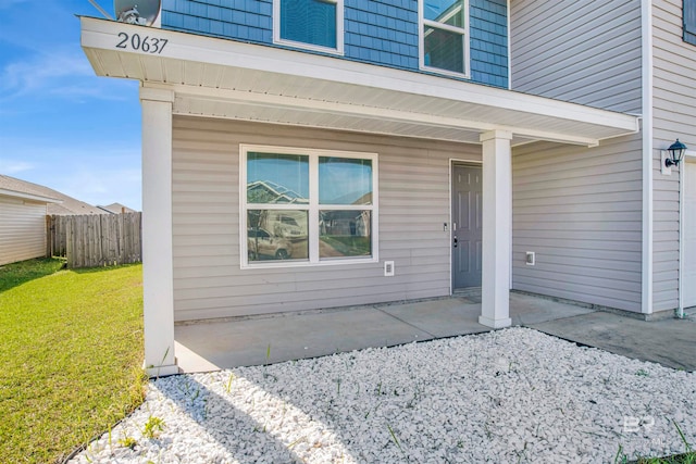 entrance to property featuring a yard