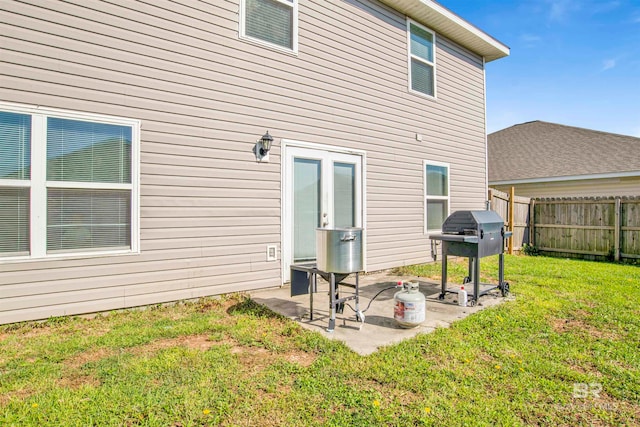 rear view of property with a lawn and a patio