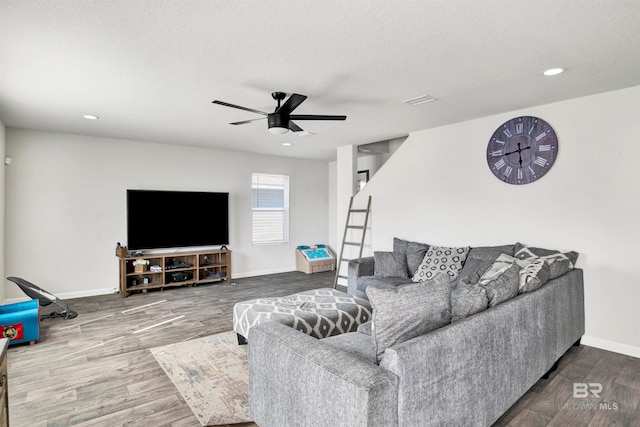 living room featuring a textured ceiling, wood-type flooring, and ceiling fan