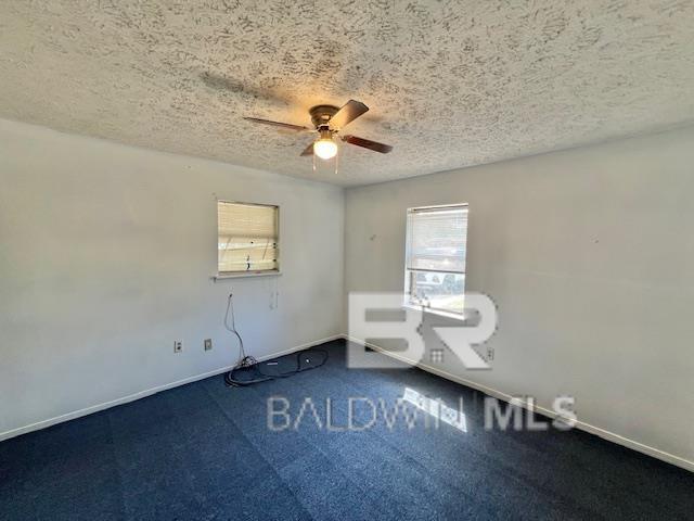 208 Lee St, Atmore, AL 36502 - spare room with a ceiling fan, baseboards, and a textured ceiling