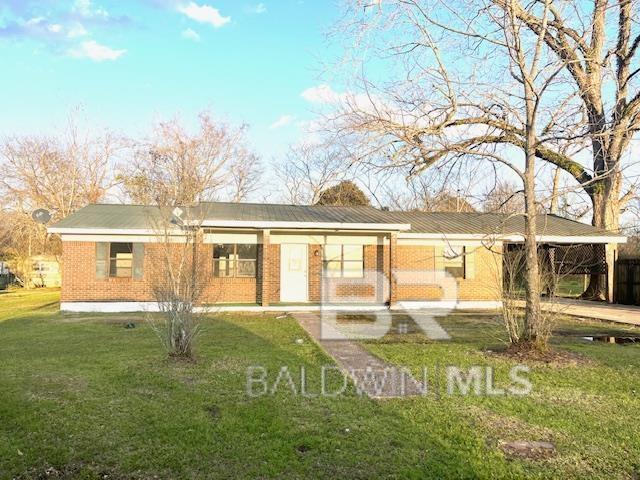 208 Lee St, Atmore, AL 36502 - back of property featuring a lawn and brick siding
