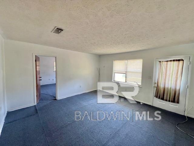 208 Lee St, Atmore, AL 36502 - interior space featuring baseboards, visible vents, and a textured ceiling
