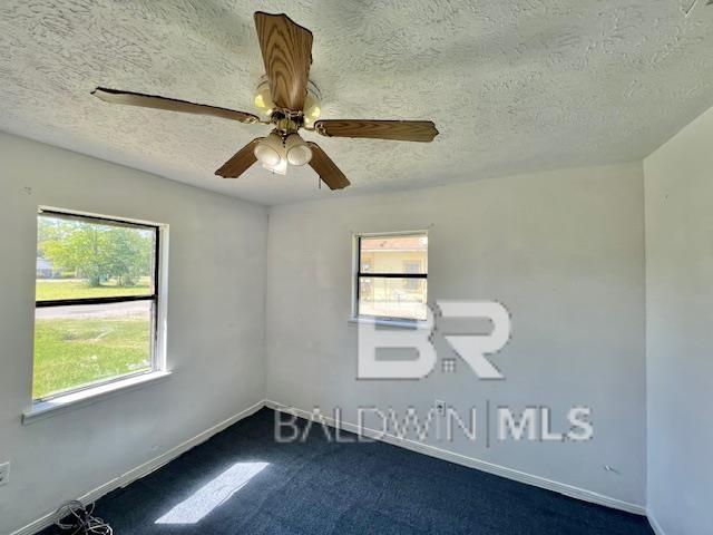 208 Lee St, Atmore, AL 36502 - unfurnished room featuring plenty of natural light, a textured ceiling, baseboards, and ceiling fan