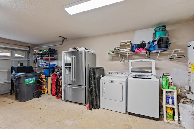 laundry room featuring a garage, a textured ceiling, and washer and dryer